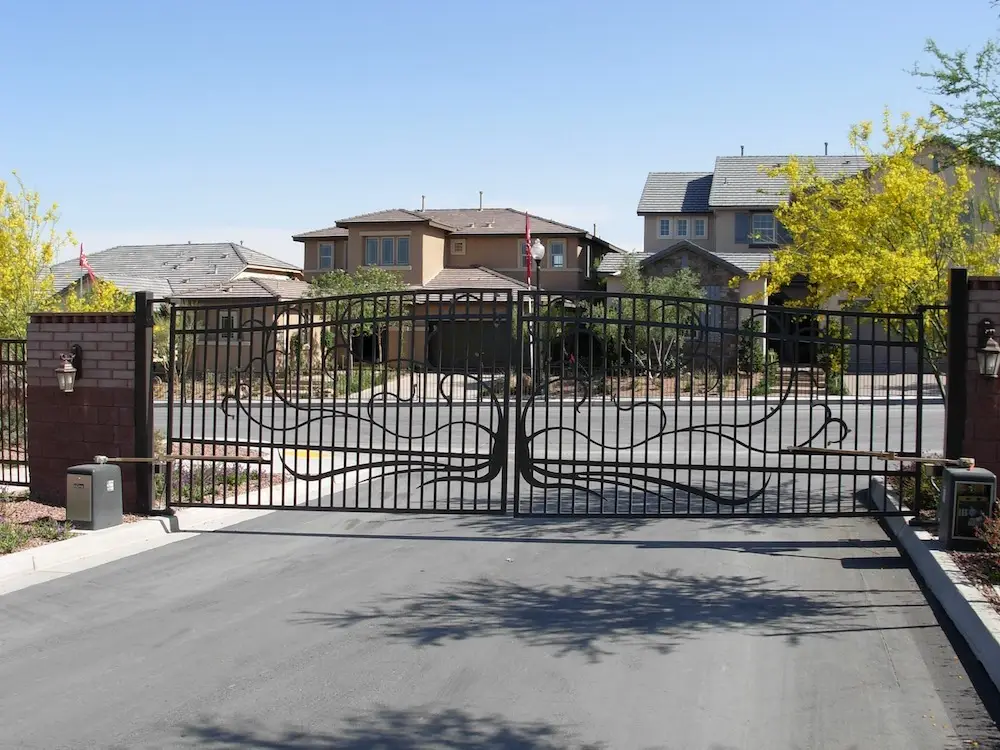 A large, decorative electric gate at the entrance of a residential property, showcasing its design and functionality for electric gate openers.