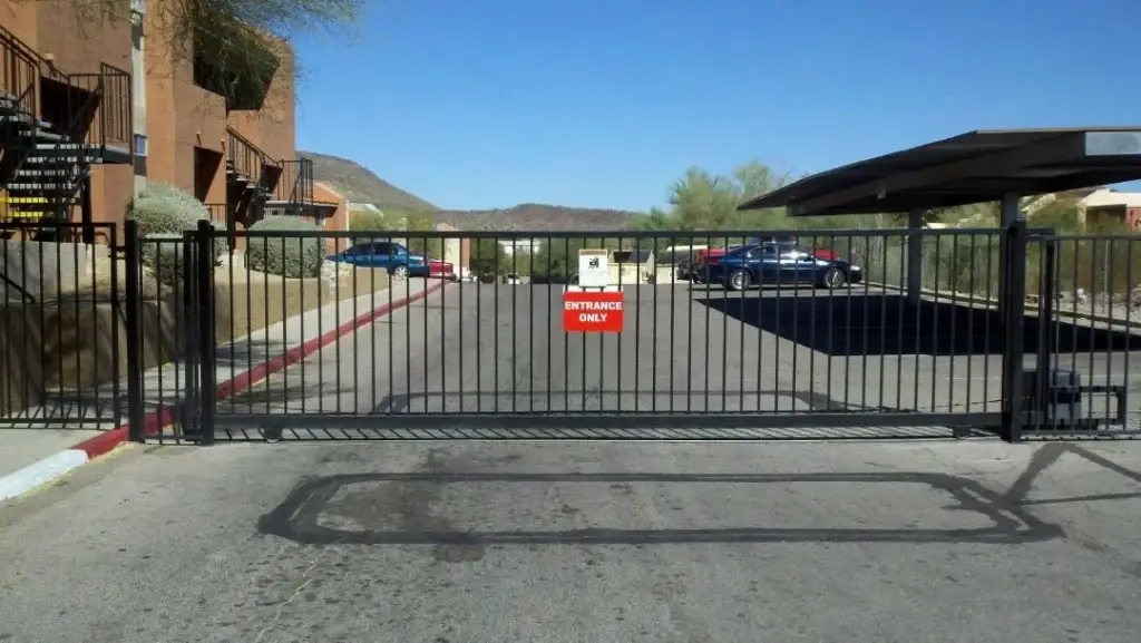 A gated apartment entrance with a clear "ENTRANCE ONLY" sign, showcasing the importance of regular Gate Maintenance and Repair.