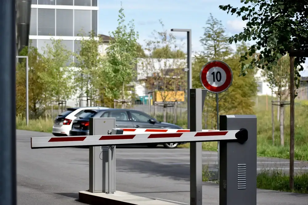 Parking lot access barrier gate with vehicle, utilizing LOOP vehicle detection system for automated control.