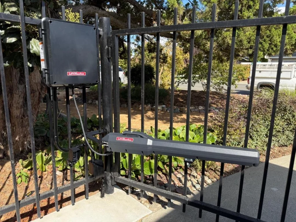 LiftMaster automatic gate opener system with control box and arm mounted on a metal gate, ready for use in automatic gate repair.