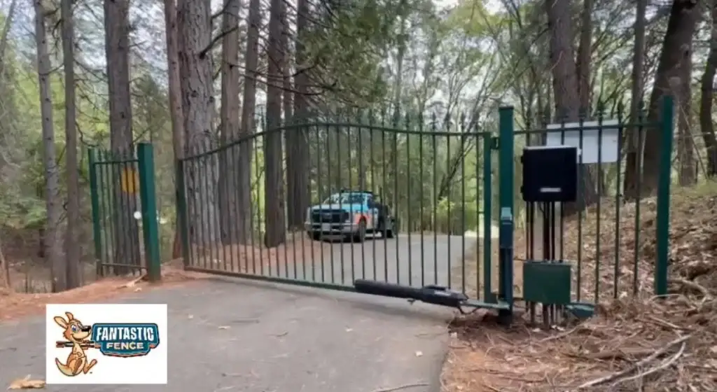 Automatic Gate Stuck Closed in a wooded area, preventing access with a vehicle in the background.