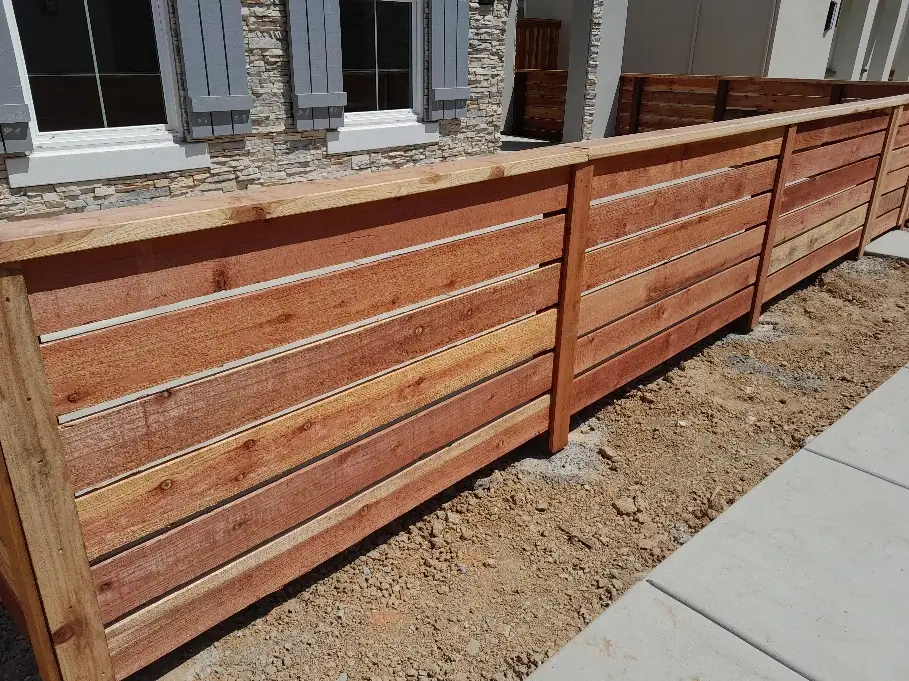 A newly installed horizontal wood fence with clean lines and natural wood finish.