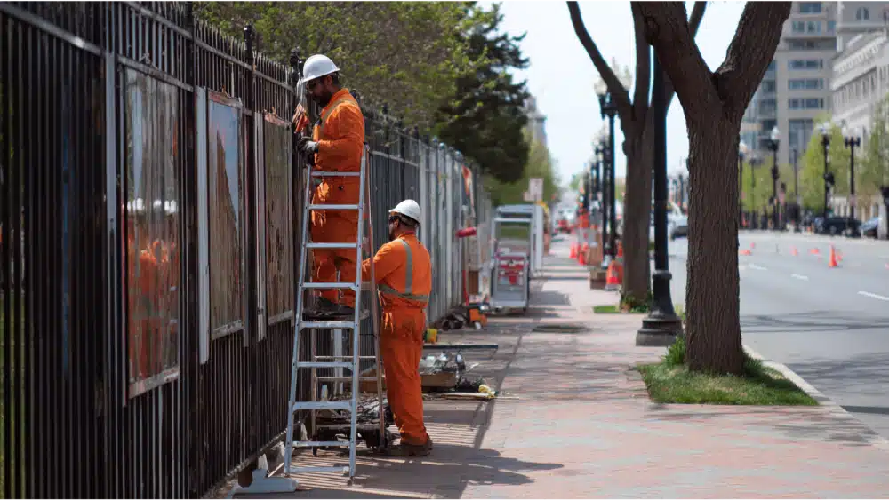 Contractor working on the fece coner of the road