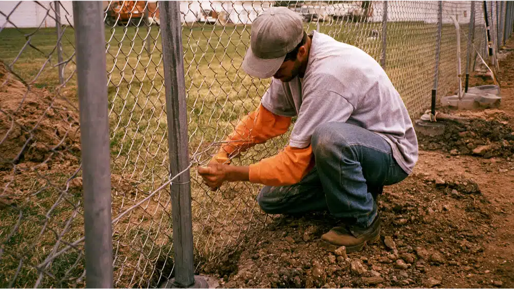 Installing chain link fence on metal posts