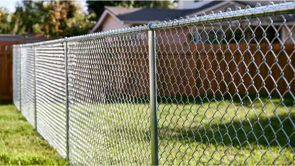 Stretching chain link fence fabric